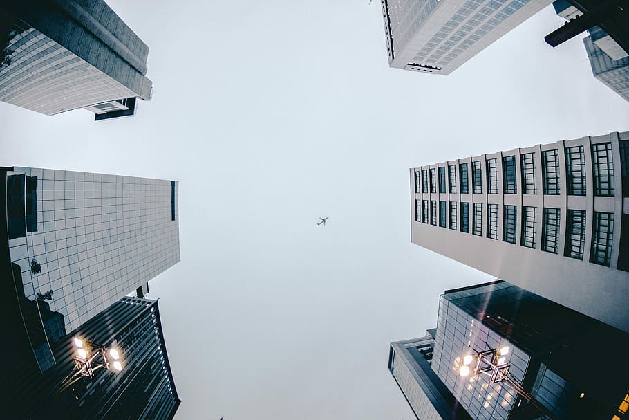 worm's eyeview photography of concrete building, low-angle photo of gray concrete buildings during daytime