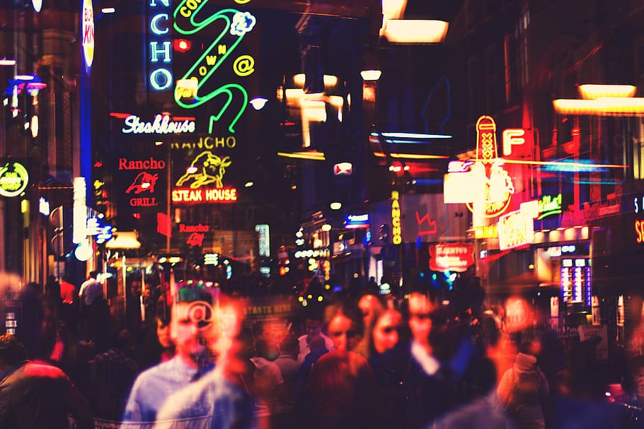 time lapse photography of crowd of people walking near lighted buildings HD wallpaper