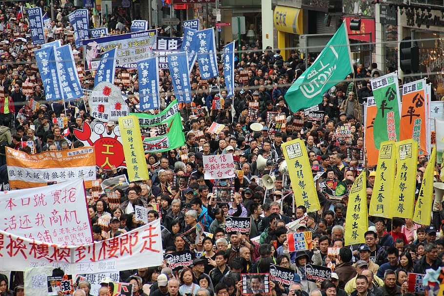 people holding flags during daytime, hong kong, china, new year march