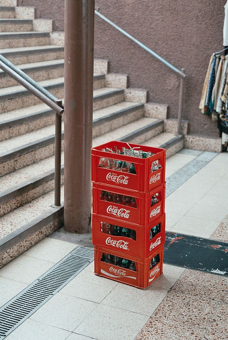 pile of four red Coca-Cola bottle crates near stairs, four Coca-Cola plastic crates near brown ceramic upstairs, HD wallpaper