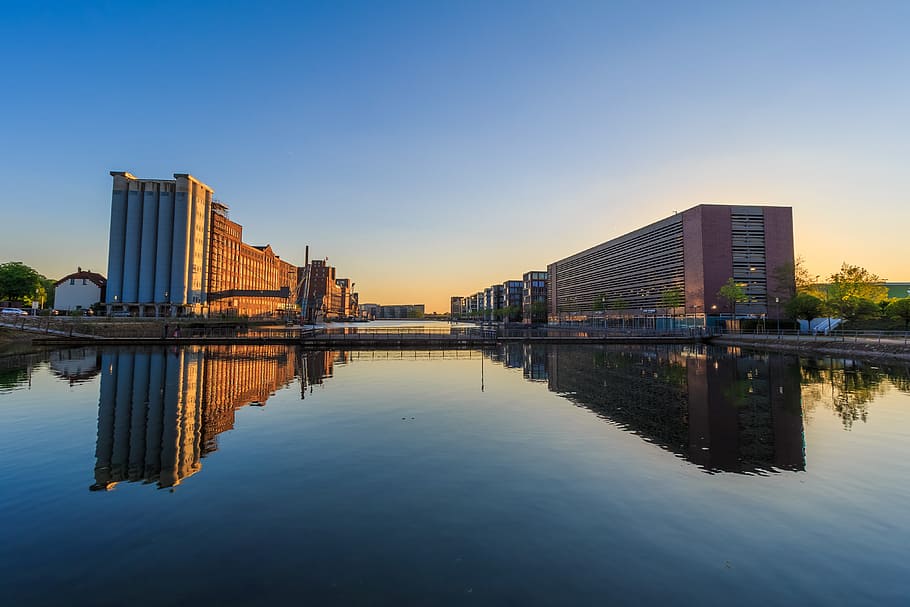 concrete buildings by the water at daytime, reflection, waters HD wallpaper