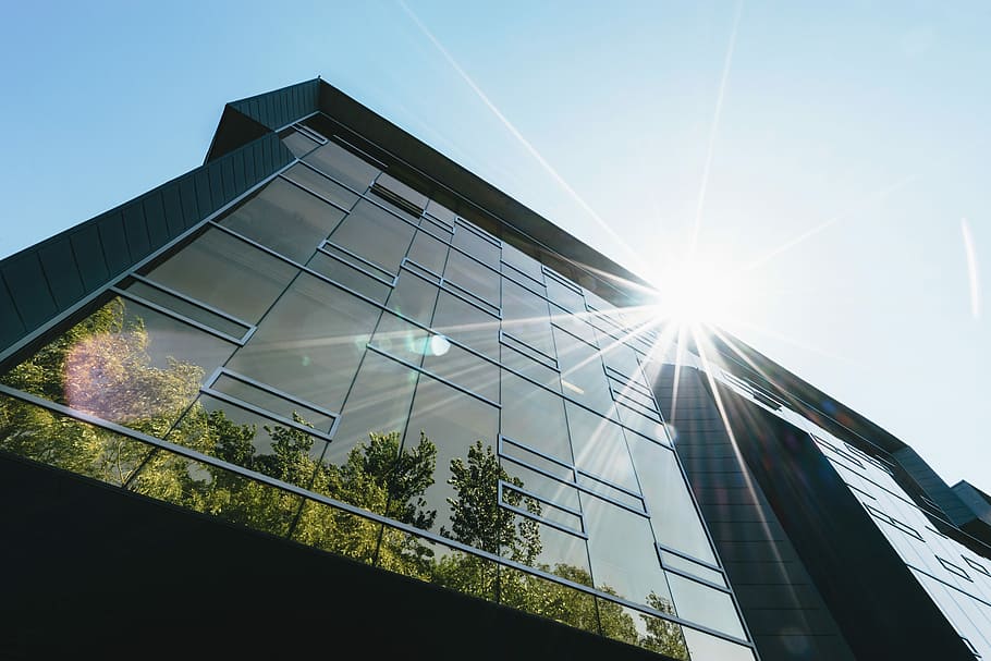 low-angle photography of high-rise commercial building during daytime, low angle photo of grey concrete building under bue sky HD wallpaper