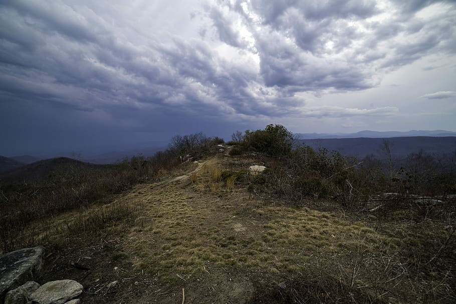 Mound at the Hilltop under lingering storm clouds at Sassafras Mountain, South Carolina HD wallpaper