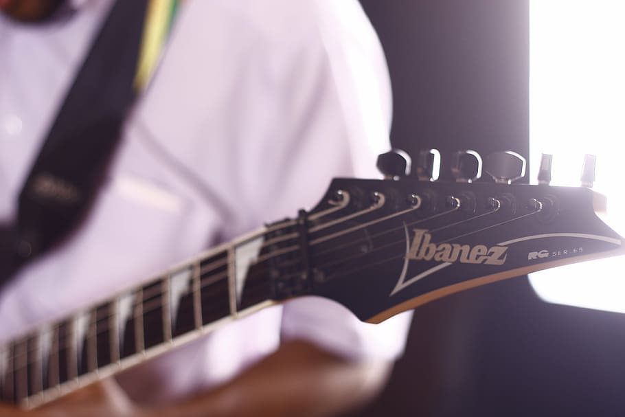 close-up photography of black Ibanez guitar, brown, headstock