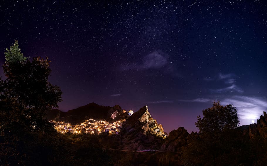 brown mountain during nighttime, town lights near mountain during nighttime HD wallpaper
