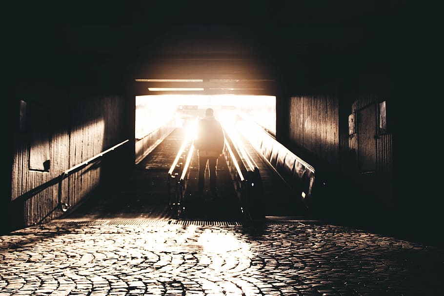 man standing at escalator during daytime, underground, sunlight HD wallpaper