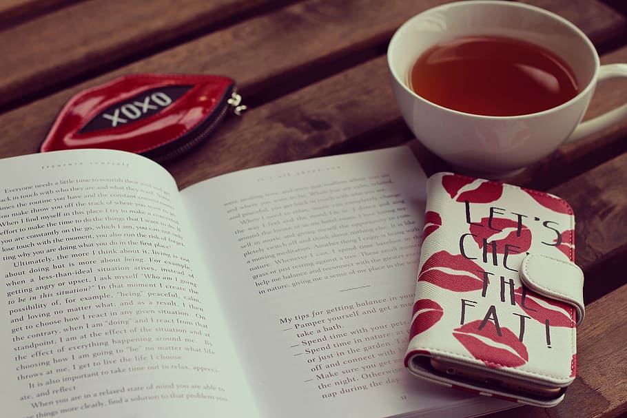 white ceramic teacup beside opened book and white and red lips print long flip phone case HD wallpaper