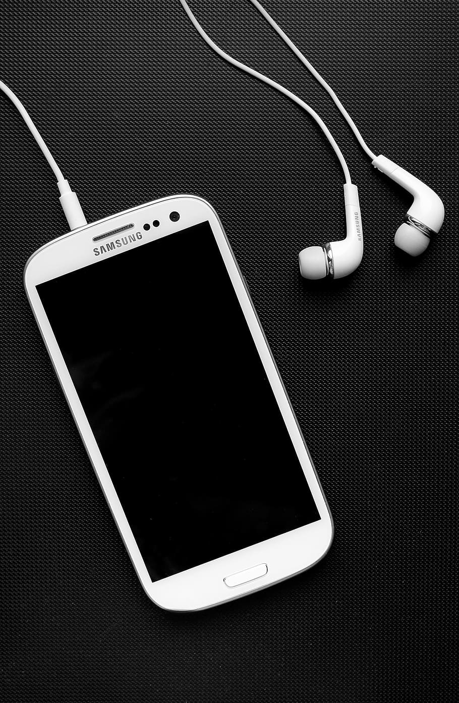 white Samsung Galaxy smartphone beside earphones, headphones, HD wallpaper