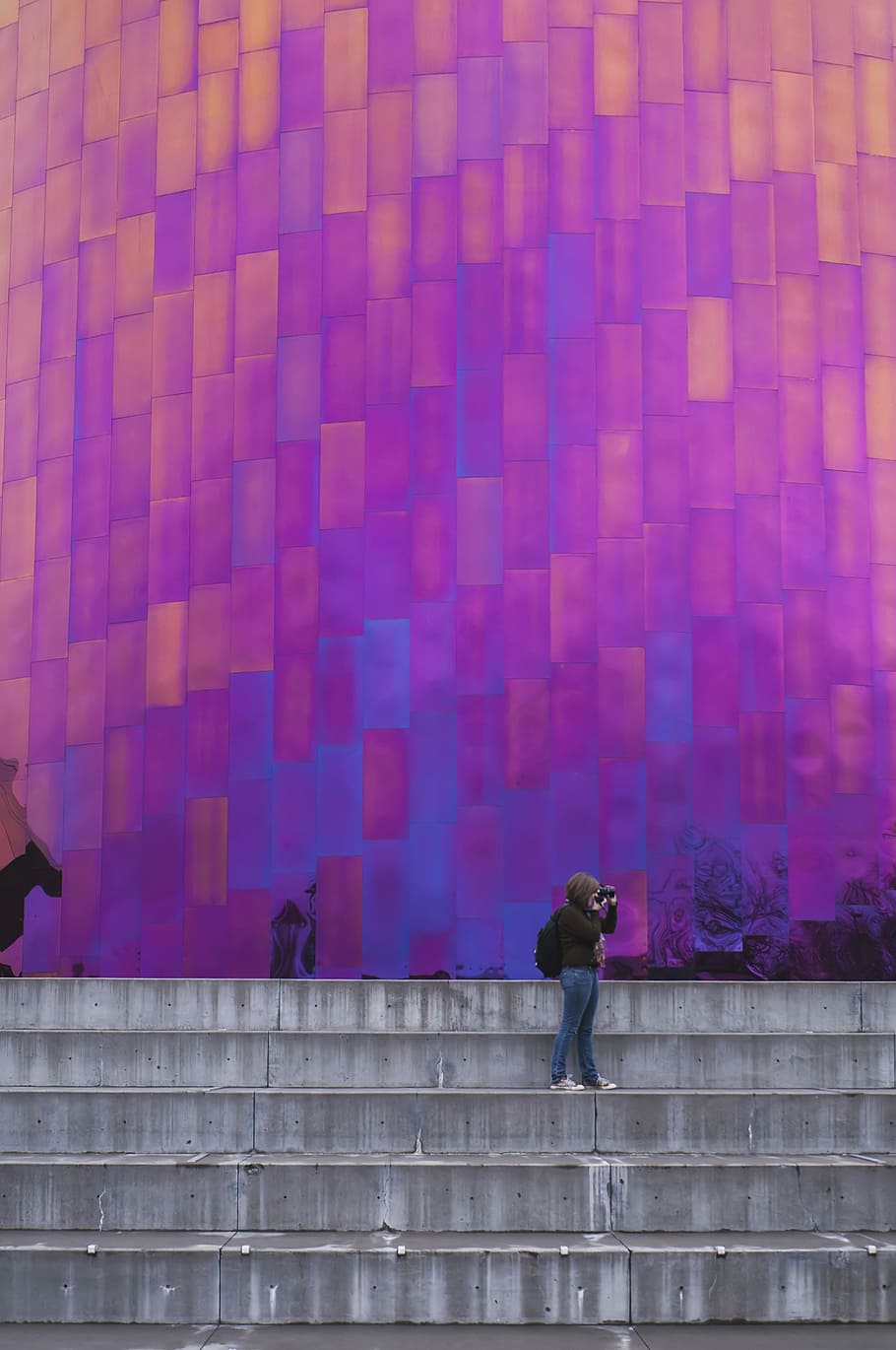 woman standing near the wall taking a picture, woman taking a photo shoot HD wallpaper