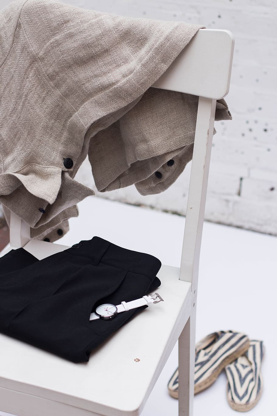 gray textile hanging on white wooden chair, white analog watch on black pants pocket on white table HD wallpaper