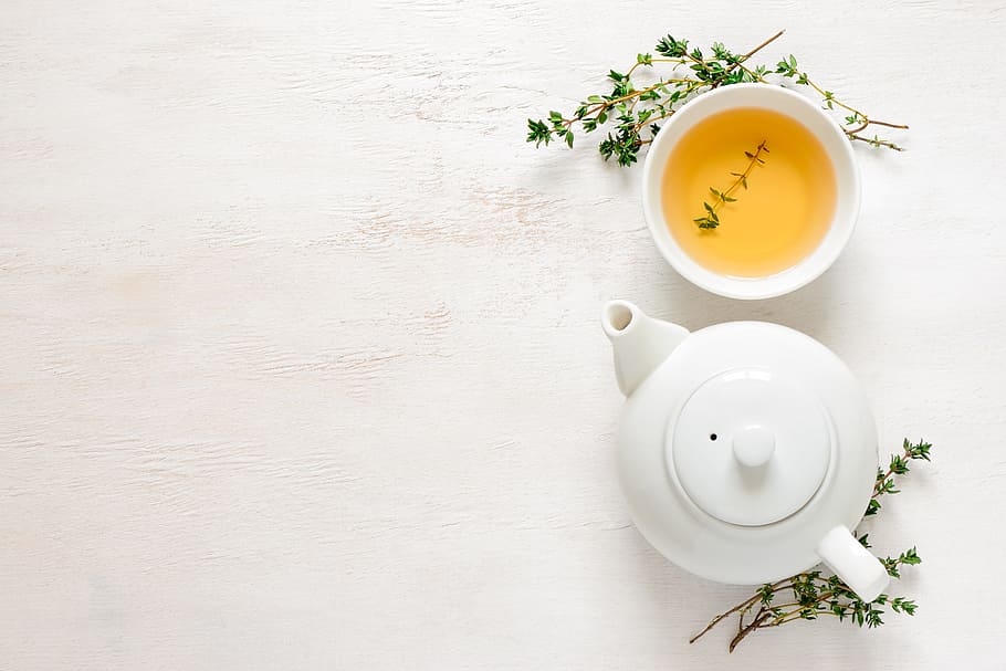 white ceramic teapot beside teacup with tea, tea pot, green tea