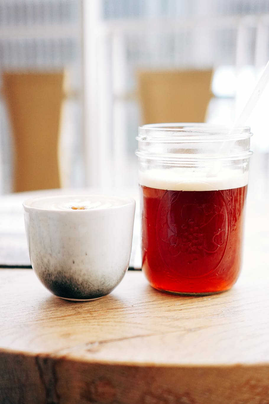 two glass containers on brown wooden board, white ceramic mug beside clear glass container filled with brown substance on brown table HD wallpaper