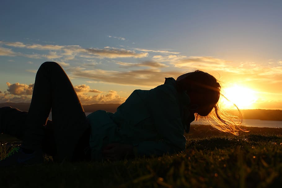 woman lying on grass, sunset, light, mood, relaxation, holiday HD wallpaper