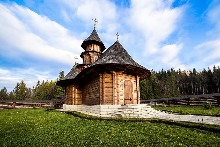 photo of brown and black cathedral during daytime, sihastria monastery putnei