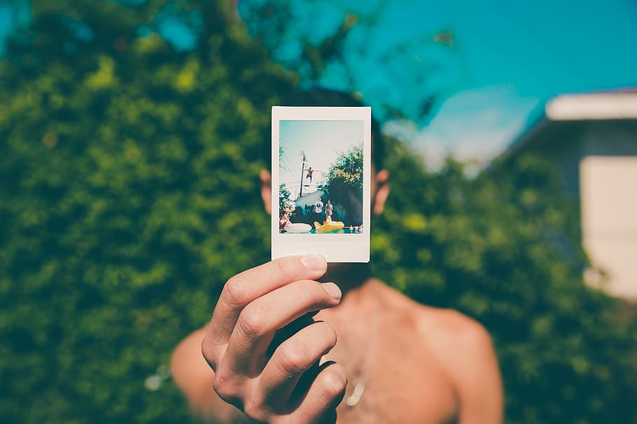 man holding photo, hand, macro, person, picture, shirtless HD wallpaper