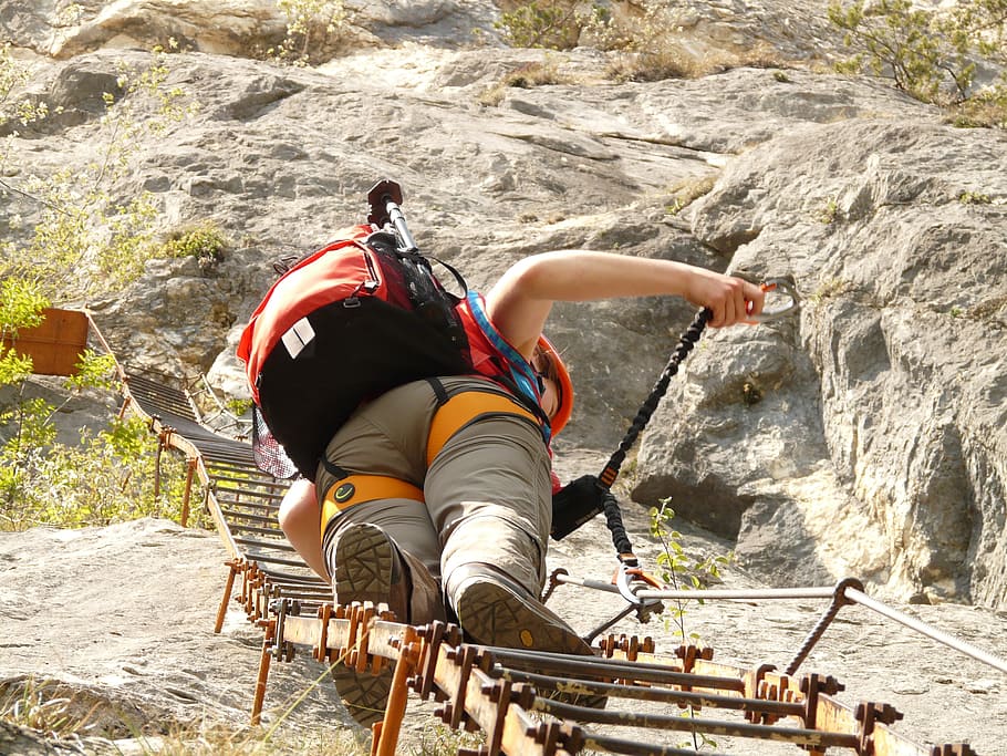 woman climbing mountain ladder, climbing platform system, head