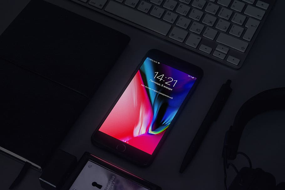space gray iPhone 6 turned on beside pen and headphones on top of table, black Android smartphone near click pen HD wallpaper
