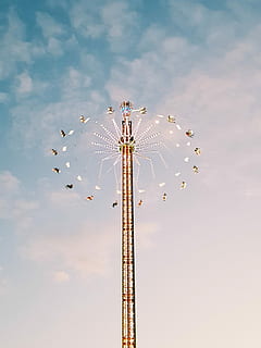 multicolored amusement park ride under white clouds during daytime, low-angle photography of gray and white amusement park ride under clear blue sky during daytime HD wallpaper