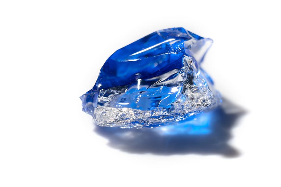 closeup photo of Sapphire on white surface, glass, piece, broken