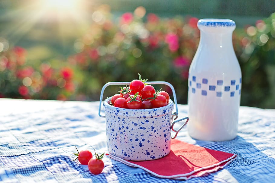 red cherries in white and blue ceramic bucket, cherry tomatoes