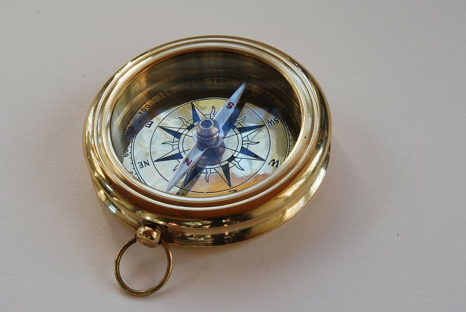 round gold-colored compass, direction, north, to find, navigation