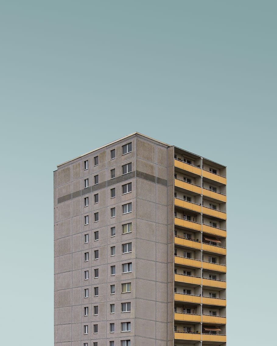 gray concrete high-rise building, architectural photography of gray high-rise building under teal sky HD wallpaper