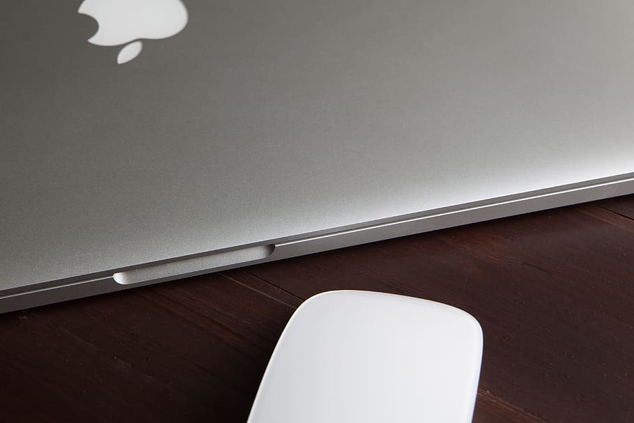 MacBook Pro laptop computer and Magic Mouse on a wooden desk HD wallpaper