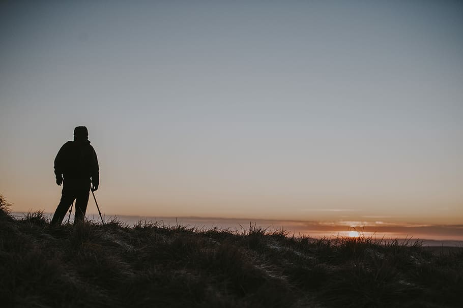 Getting up early for the perfect shot, man standing on mountain top during sunset HD wallpaper