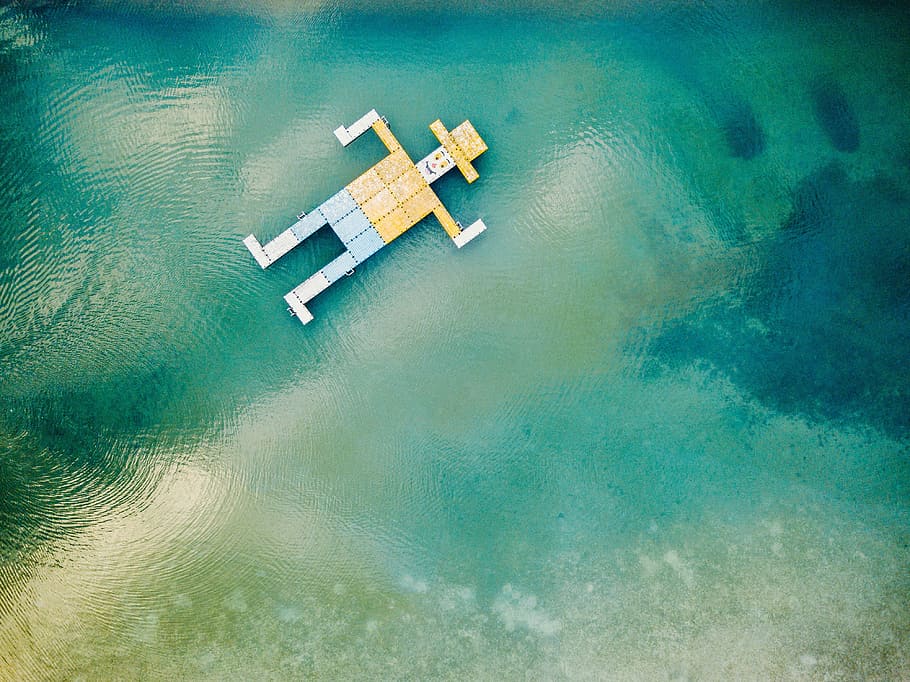 wooden toy floating on body of water, man with yellow hat floating on body of water illustration HD wallpaper