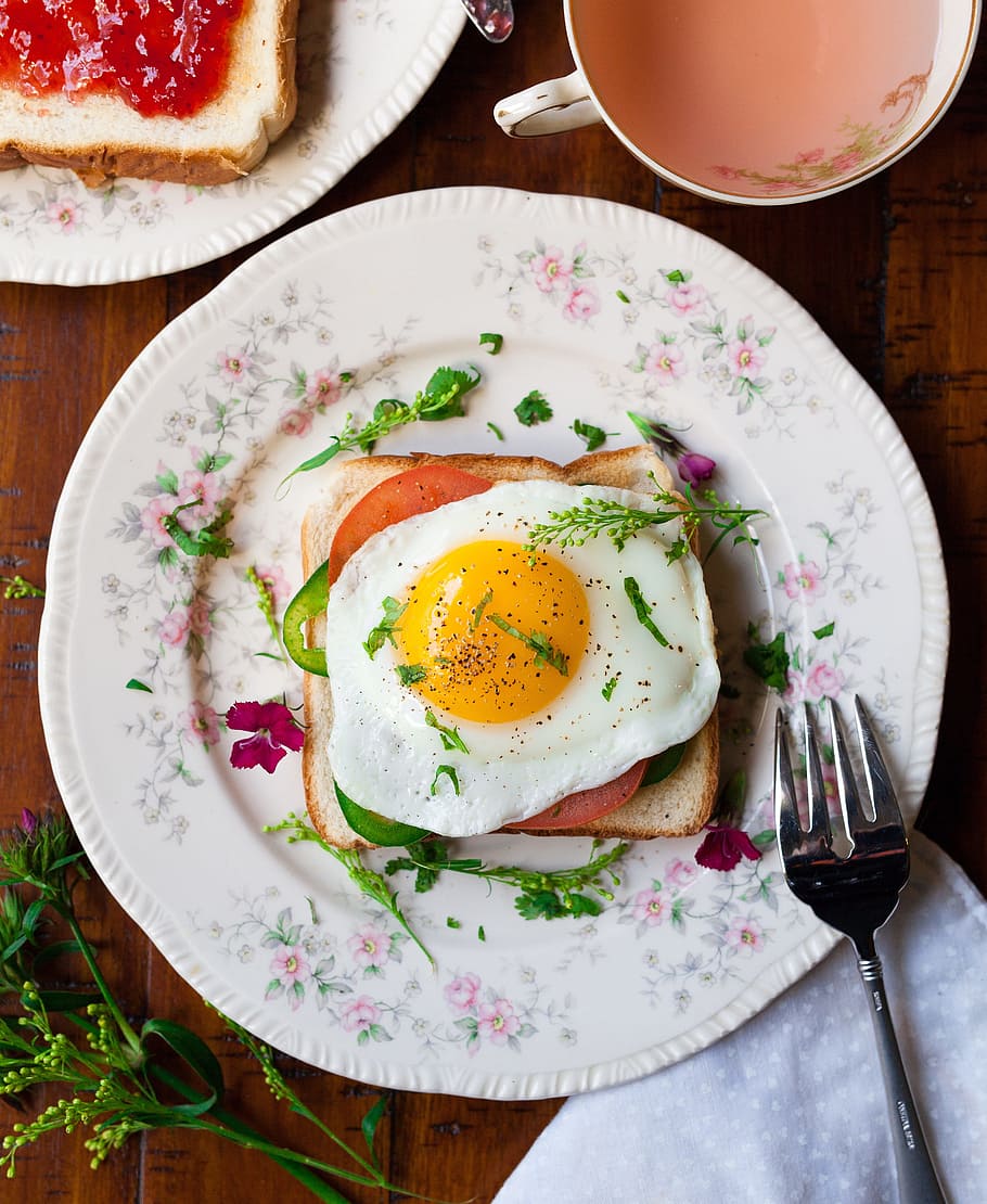 friend egg on bread on white ceramic plate beside stainless steel fork HD wallpaper