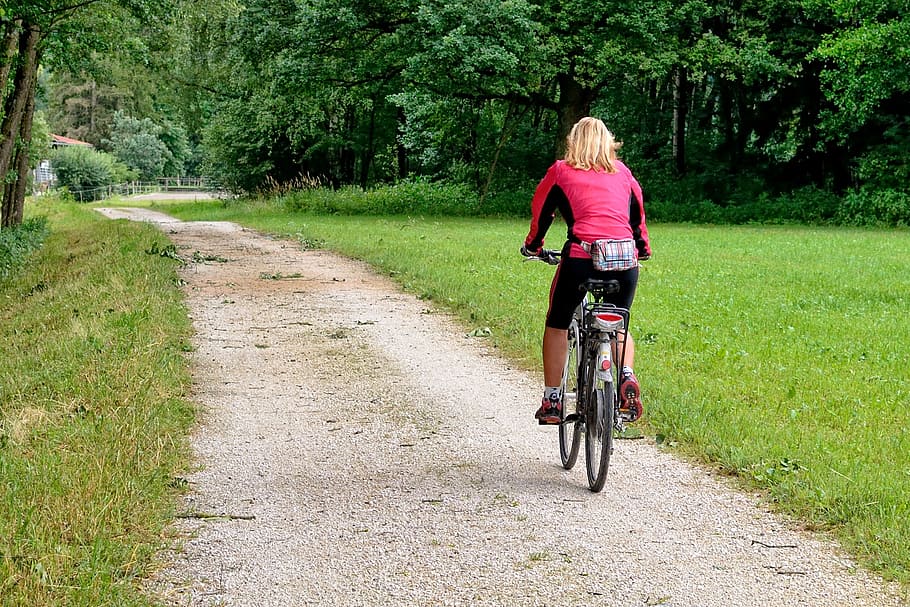woman cycling on pathway during daytime, cycle path, bicycle path HD wallpaper