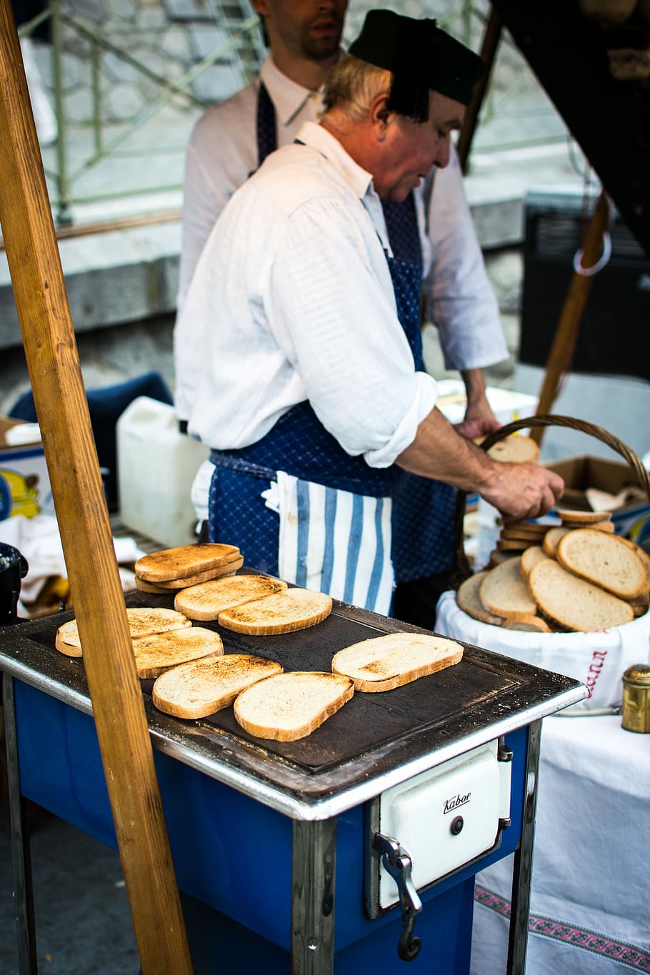 Traditional Czech toasted bread with garlic, hands, market, outside