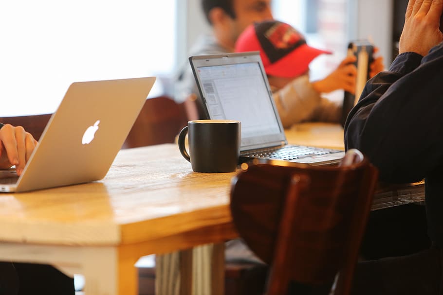 silver MacBook beside black ceramic mug on top of brown wooden table HD wallpaper