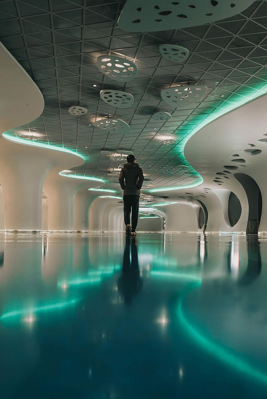 person walking in building, person in grey hoodie walking in middle of room HD wallpaper