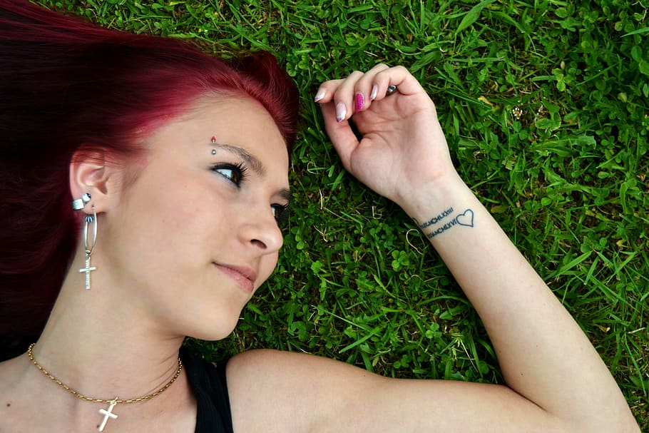 woman wearing black spaghetti-strap top lying on green grass field HD wallpaper