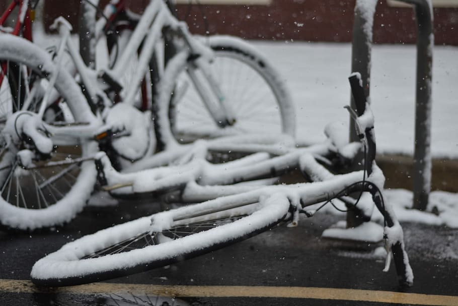 two snow covered bicycle on street, black bicycles covered with snow HD wallpaper