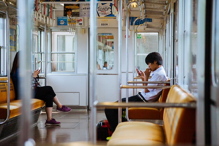 man and woman sitting chair inside the train, man and woman facing each other at the train HD wallpaper