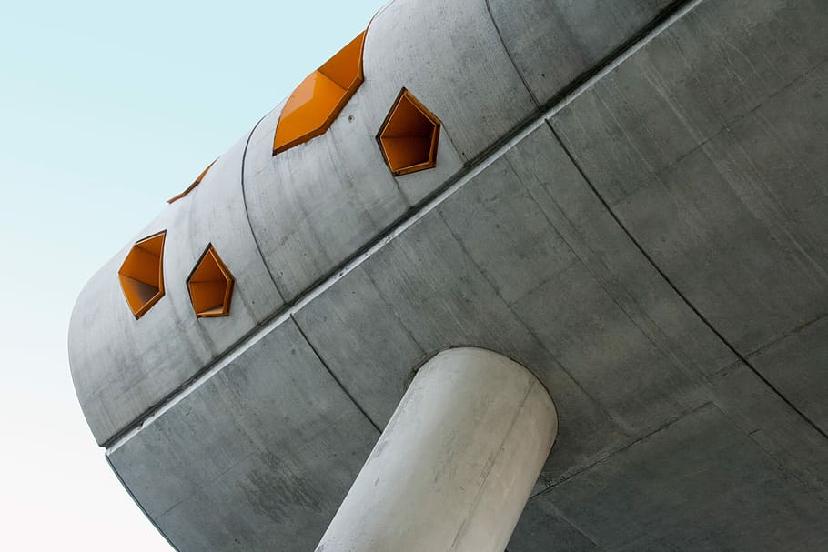low angle photography of grey structure under blue sky during daytime, low angle photo of gray and orange concrete building HD wallpaper