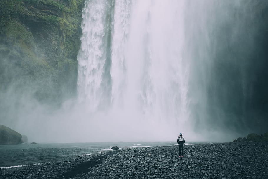 person standing near mountain falls, Skógafoss Waterfall, flowing HD wallpaper