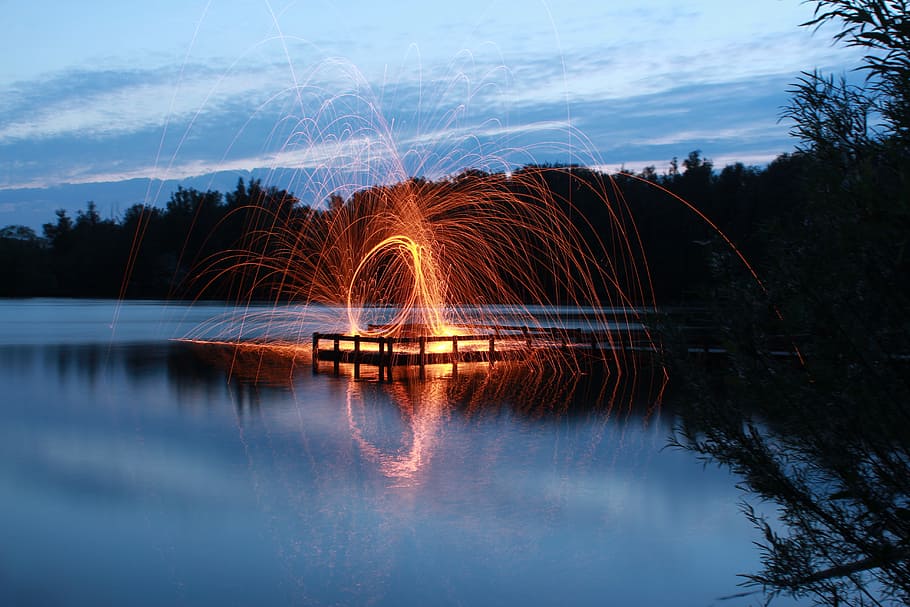 slow shutter photo of fire dance, fireworks near body of water HD wallpaper
