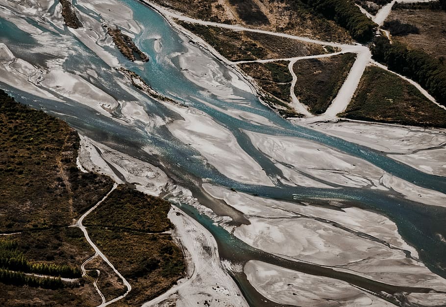 aerial photo of islanb, water flowing through area in between forest HD wallpaper