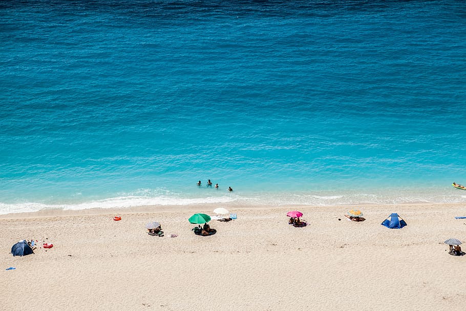group of people near seashore at day time, people on seashore sunbathing under daytime, HD wallpaper