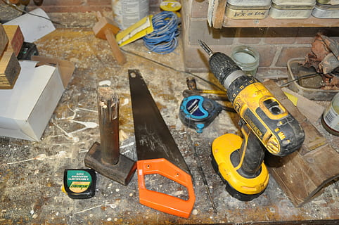 black and yellow DEWALT cordless power drill near orange and black wood saw HD wallpaper