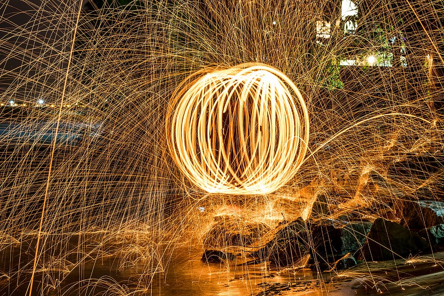 time lapse photography of fire dancing, steel works photography near brown rocks HD wallpaper