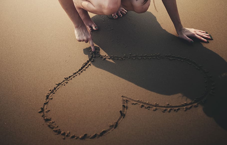 woman drawing heart shape on beach sand, human body part, human hand HD wallpaper