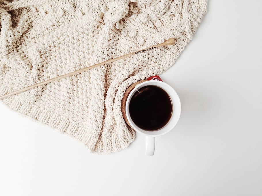 red ceramic mug on white surface, white mug filled with black liquid substance HD wallpaper