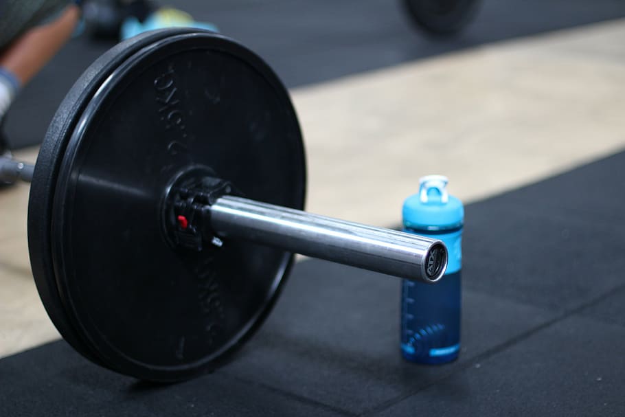 close-up photo of black barbell beside blue sports bottle, break HD wallpaper