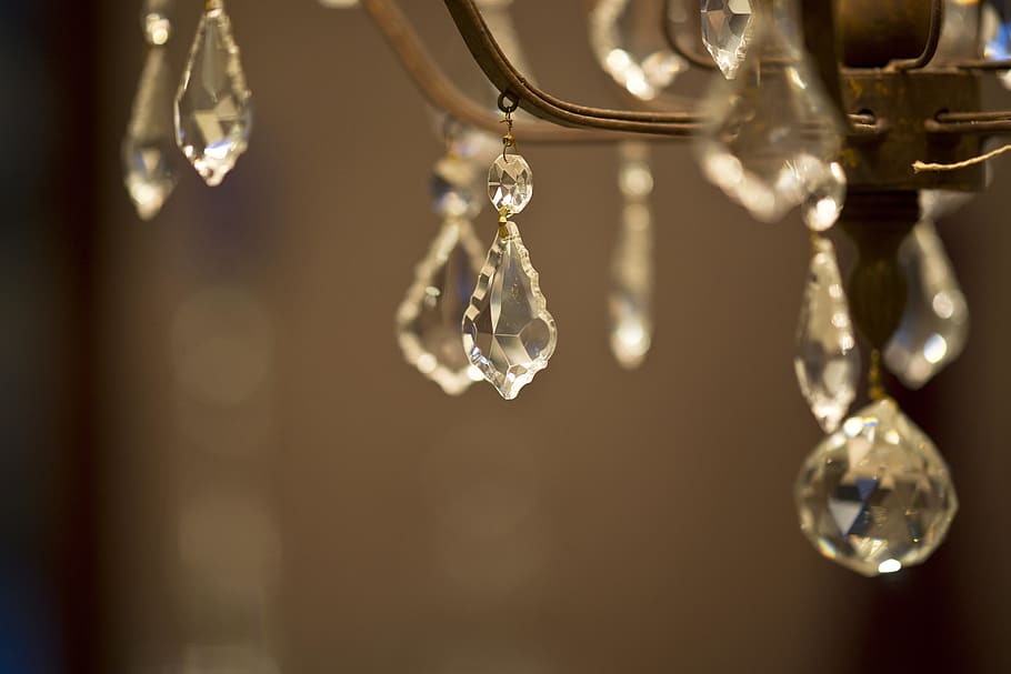 selective focus photography of clear glass pendant on grey metal base