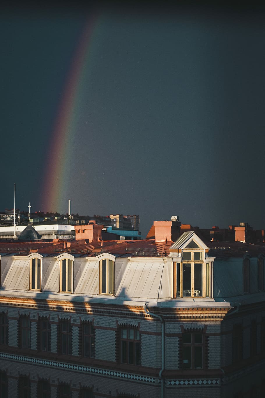 rainbow over buildings, white and brown concrete building under rainbow HD wallpaper