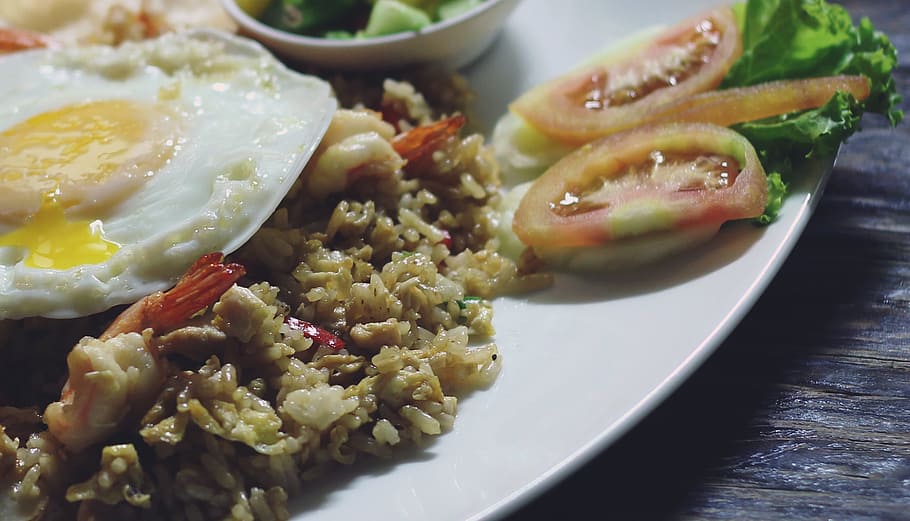 slice tomato beside the rice with sunny side up, Fried Rice, Special